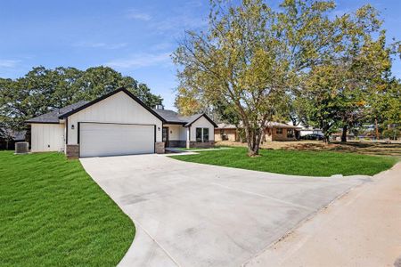 View of front of home with a front yard, a garage, and central air condition unit