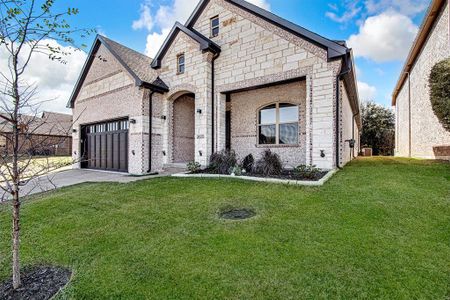 View of front of home featuring a garage and a front lawn