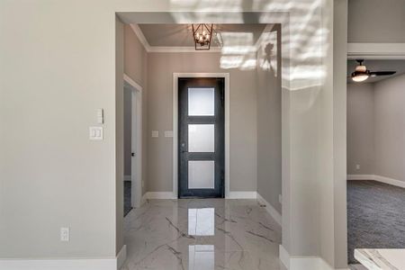 Entrance foyer with baseboards, marble finish floor, and a chandelier