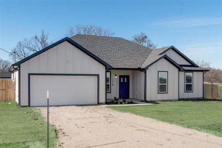 Modern farmhouse featuring a front lawn and a garage