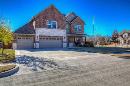 View of front of property featuring covered porch and a garage