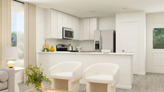 Kitchen featuring white cabinets, kitchen peninsula, appliances with stainless steel finishes, a breakfast bar, and light hardwood / wood-style floors