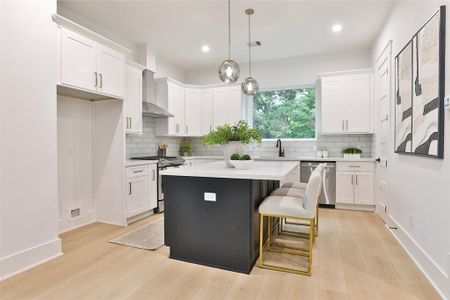 MODEL HOME COMPLETED AT 2413 FRANCIS. Experience the luxury of a spacious, open-concept kitchen with ample seating at the island bar and the convenience of a large walk-in pantry just steps away.