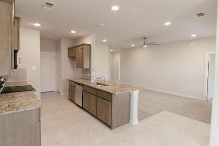 Kitchen featuring tasteful backsplash, ceiling fan, range, dishwasher, and light tile patterned floors