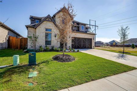 View of front of home with a front lawn and a garage