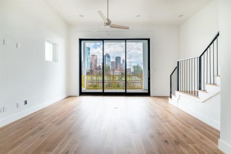 Tall open living area with the downtown view framed like a piece of art!