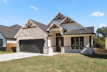 View of front of home featuring a garage and a front yard