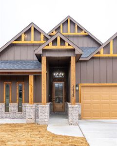 Doorway to property with a garage