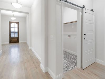 Entryway featuring a barn door and light hardwood / wood-style floors