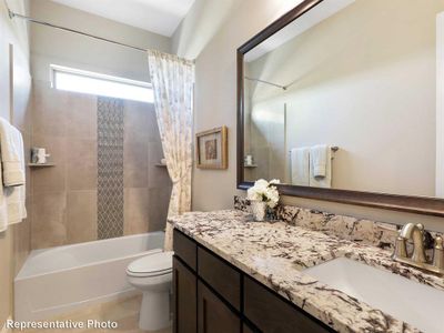 Full bathroom featuring vanity, shower / bathtub combination with curtain, and toilet