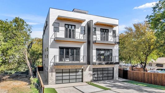 Contemporary house featuring a balcony and a garage