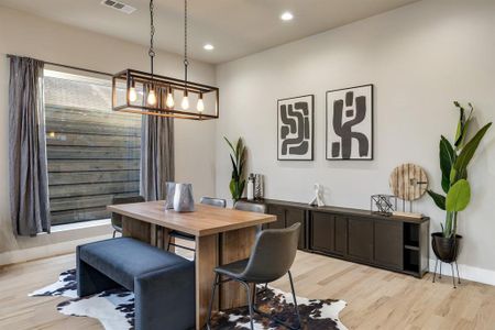 Dining area featuring an inviting chandelier and light wood-type flooring