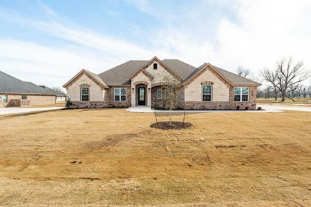 French provincial home featuring a front yard