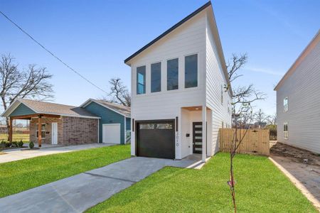 Modern home with a front lawn and a garage