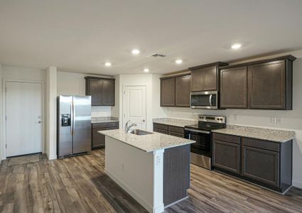 Enjoy stunning granite countertops and designer wood cabinetry in this kitchen.