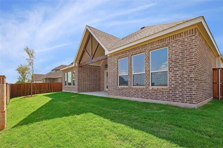 Rear view of property with a patio and a lawn