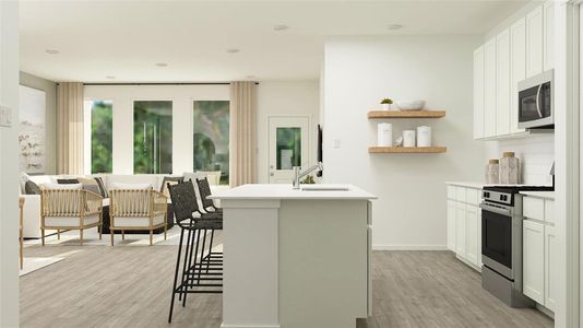 Kitchen featuring a kitchen bar, sink, white cabinetry, a center island with sink, and stainless steel appliances