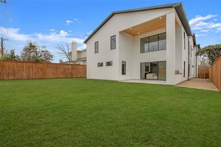 Back of property with a lawn and a patio area