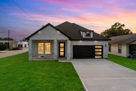 This modern gem sits on an oversized corner lot! The exterior elevation features a stunning combination of stone and brick, complemented by a refined black & white color palette and soffit lights that add a touch of sophistication.