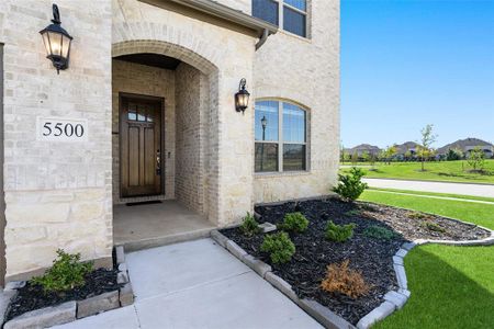 Doorway to property with a lawn