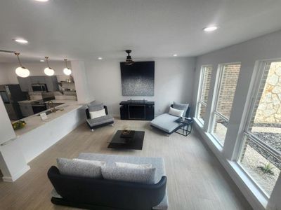 Living room featuring wood-type flooring and sink