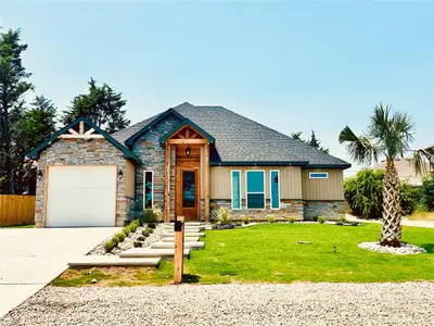 View of front of house featuring stone siding, driveway, a garage, and roof with shingles View of front of house featuring stone siding, driveway, a garage, and roof with shingles