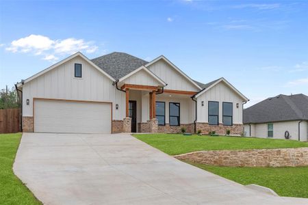 View of front of property with a garage and a front yard