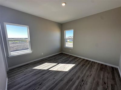 Unfurnished room featuring dark hardwood / wood-style flooring