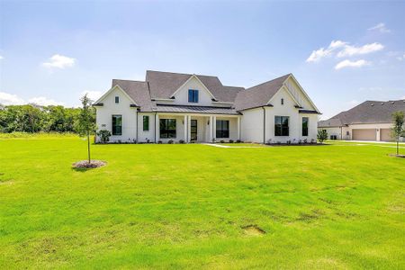 View of front of property with a garage and a front yard