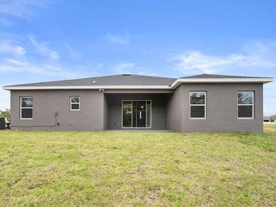 A covered lanai and large backyard provide desirable outdoor living space.