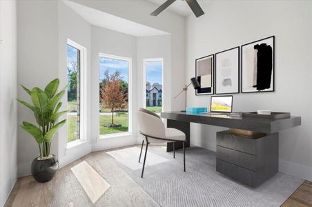 Office with hardwood / wood-style flooring and ceiling fan