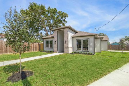 The welcoming front exterior features beautiful landscaping