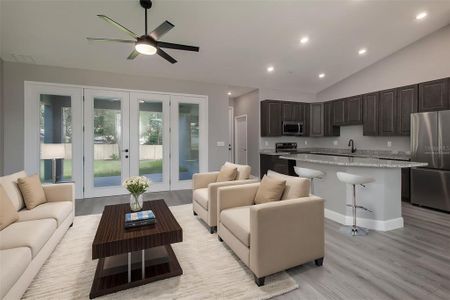 Virtually staged to show scale -family room to kitchen area