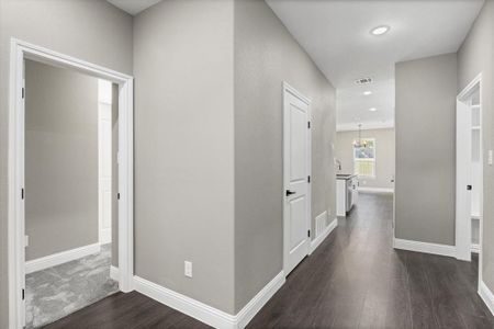 Hallway with dark wood-type flooring and sink