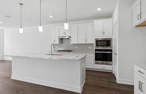 Bright kitchen with oversized island *real home pictured