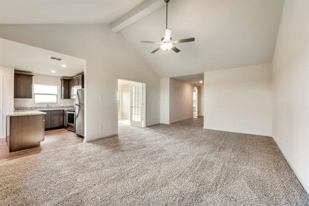 living room with light carpet, high vaulted ceiling, beamed ceiling, and ceiling fan