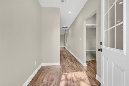 Corridor with light hardwood / wood-style flooring