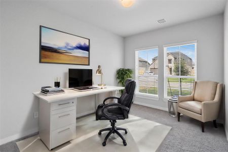 Quietly nestled in front of the home is the handsome home office. Featuring plush carpet, custom paint and large windows with privacy blinds.