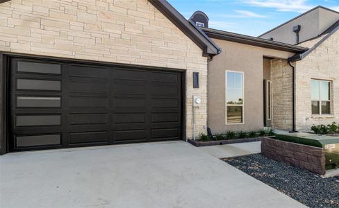 View of exterior entry with a garage