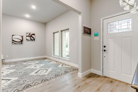 Foyer entrance featuring light hardwood / wood-style floors