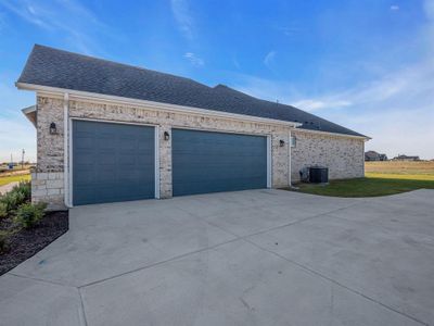 View of home's exterior featuring central air condition unit and a garage