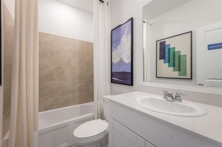 Full bathroom with shower / tub combo with curtain, vanity, and toilet