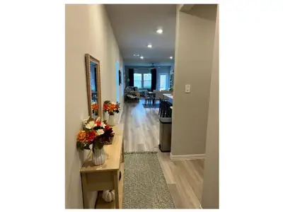 Hallway with light hardwood / wood-style floors