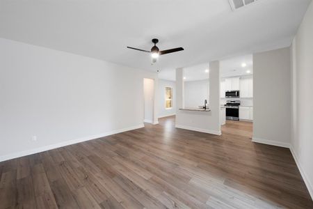 The living room of this home is a warm and inviting space to enjoy family time. In addition, the kitchen has a keyhole and breakfast counter that connects to the living room.