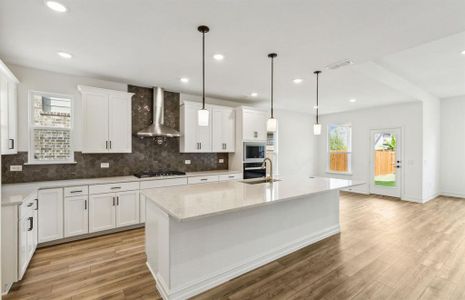 Bright kitchen with oversized island *real home pictured