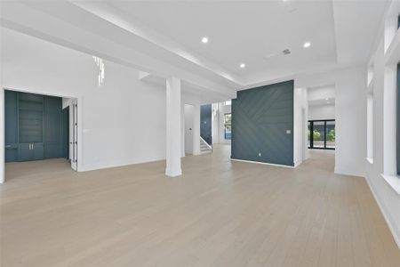 Step through the front door to the formal dining space that offers a double height tray ceiling, great natural light and white oak floors that flow seamlessly throughout. The study/library is featured just off the main entry.