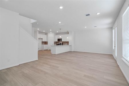 Another view of the great room looking to the kitchen and dining/breakfast areas.