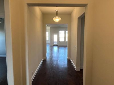 Hallway with dark hardwood / wood-style floors