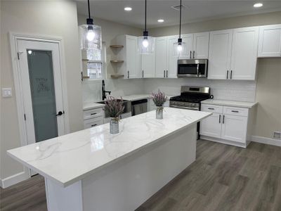 Huge island, pantry, and stainless steel appliances make this kitchen a dream.