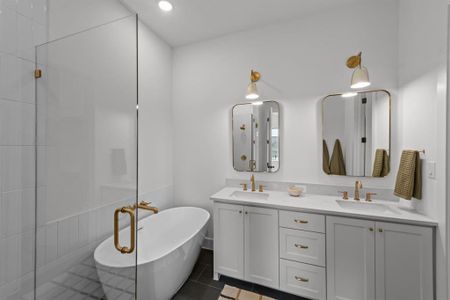 Bathroom featuring tile patterned floors, a bathing tub, and vanity